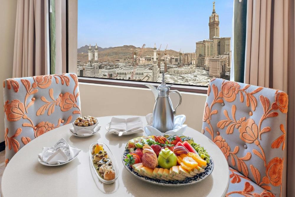 In-room dining at Anjum Makkah with city backdrop